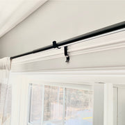 Additional curtain rod support for window frames wider than 60”.